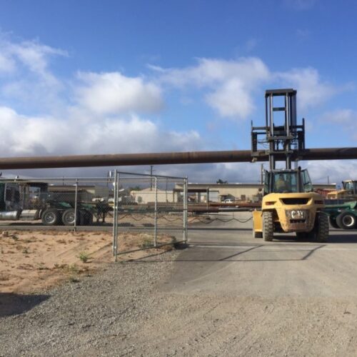 Side view of Big Bear pipes above the fence